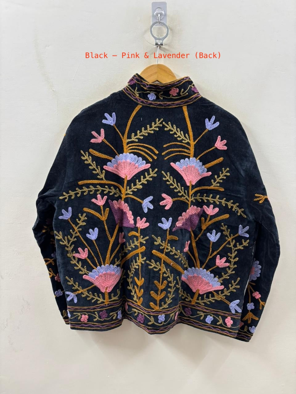 Embroidered jacket with floral patterns on a white background