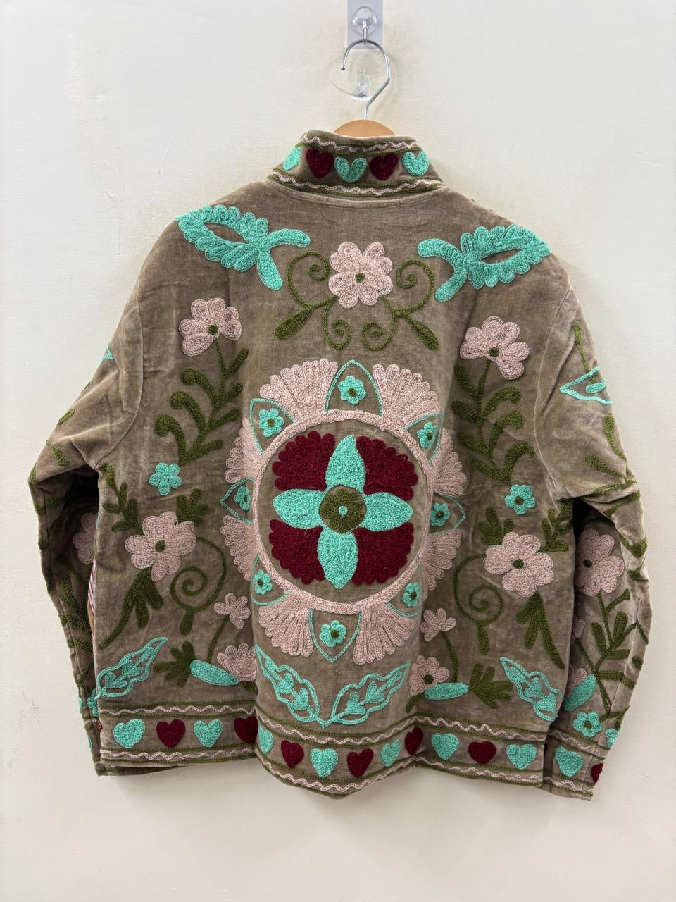 Embroidered sweater with floral patterns on a white background